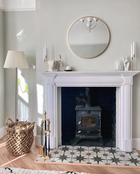 a living room with a fire place and rugs on the floor in front of it