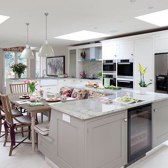 a kitchen filled with lots of counter top space next to a dining room table and chairs