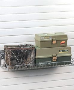 three boxes are stacked on top of each other in a wire basket next to a garage door