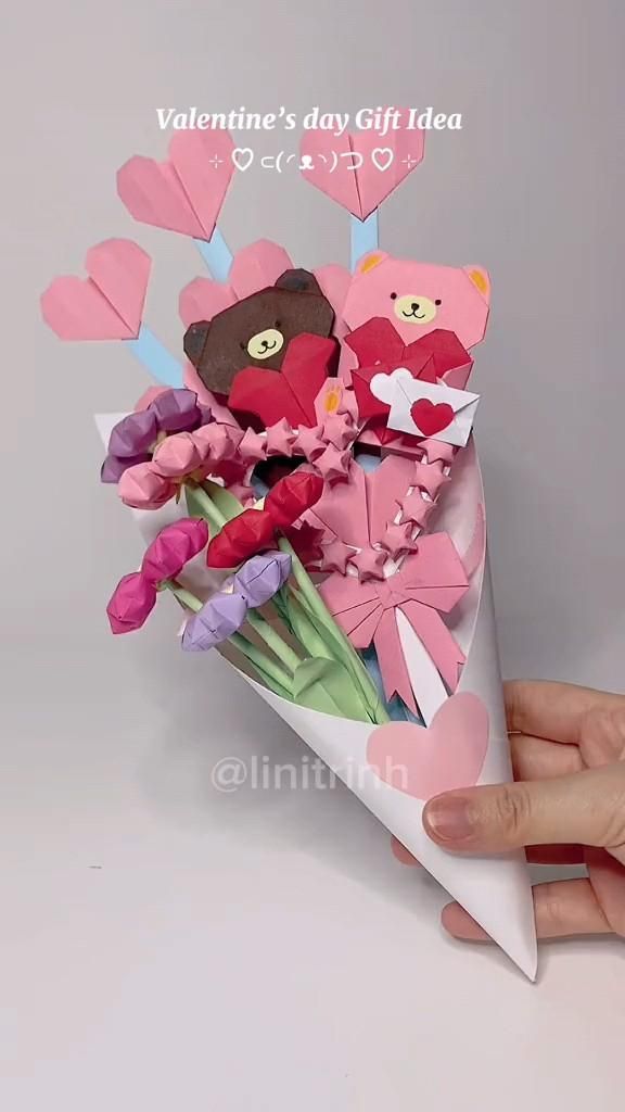 someone is holding a bouquet of flowers with paper cut out to look like teddy bears