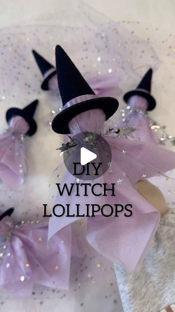 the witch lollipops are on display in front of a white tablecloth