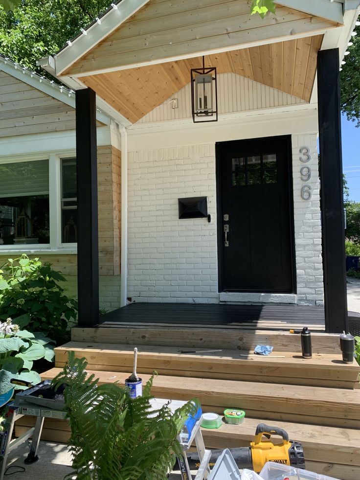 a porch with steps leading up to the front door