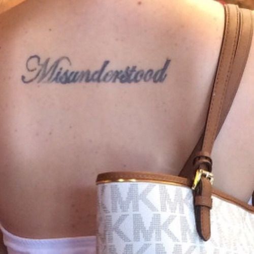 the back of a woman's shoulder with a tattoo that reads, misondered