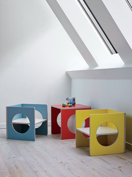 three different colored tables sitting on top of a hard wood floor next to a white wall