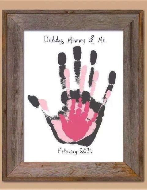 a handprint is displayed in a frame with the words daddy's mommy and me