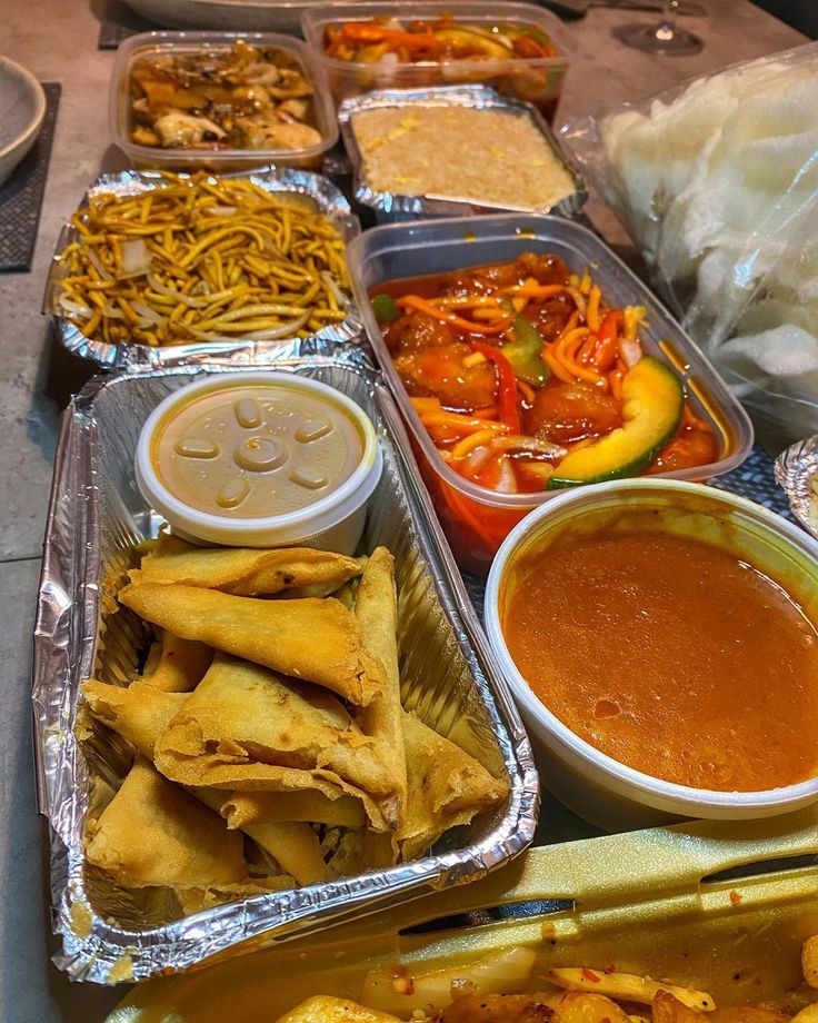 several trays filled with different types of food and condiments on the table