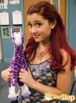 a girl holding a purple giraffe stuffed animal