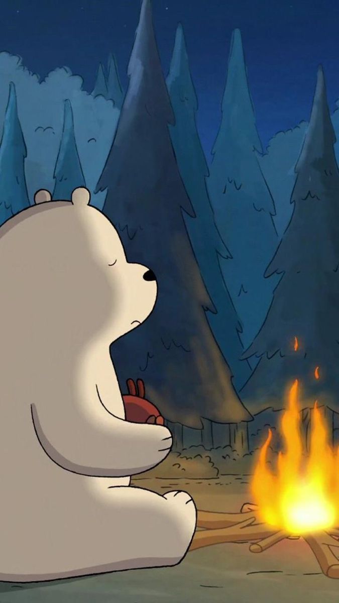 a polar bear sitting in front of a campfire