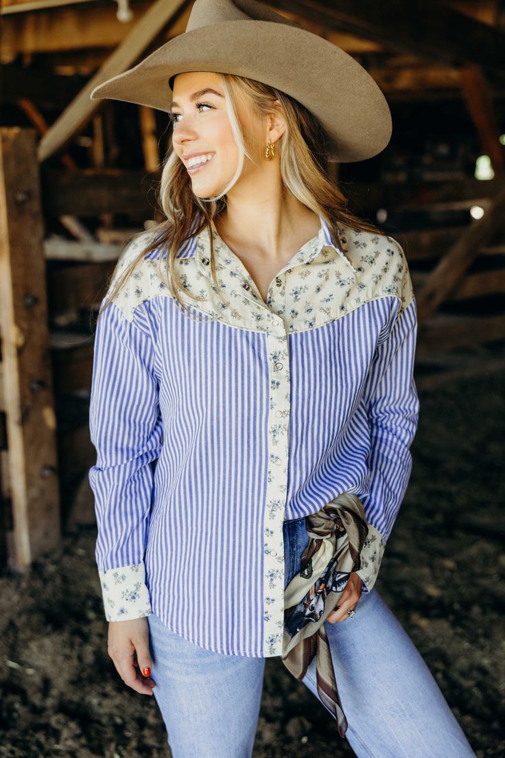 Yeehaw to the cutest cowgirl shirt in town! The Dollie Shirt features a playful mix of floral print and stripes, perfect for bringing some fall flair to your western style. With a classic button down design in a beautiful blue color, you'll want to wrangle this top into your wardrobe ASAP. Courtney is wearing size small paired with The Derek Jeans, The Adaire Mules, Felt Cowboy ProHat and Cattle Guard Wild Rag Cattle Guard, Wild Rag, Cowgirl Shirts, Curvy Dress, Heritage Collection, Western Style, Beautiful Blue, Bottoms Pants, Western Fashion