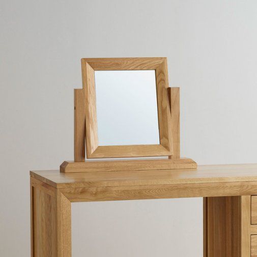 a wooden desk with a mirror on it