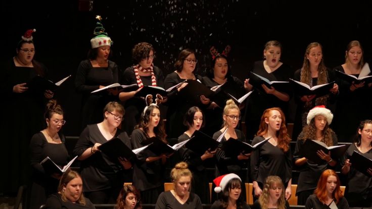 a group of women singing christmas carols together