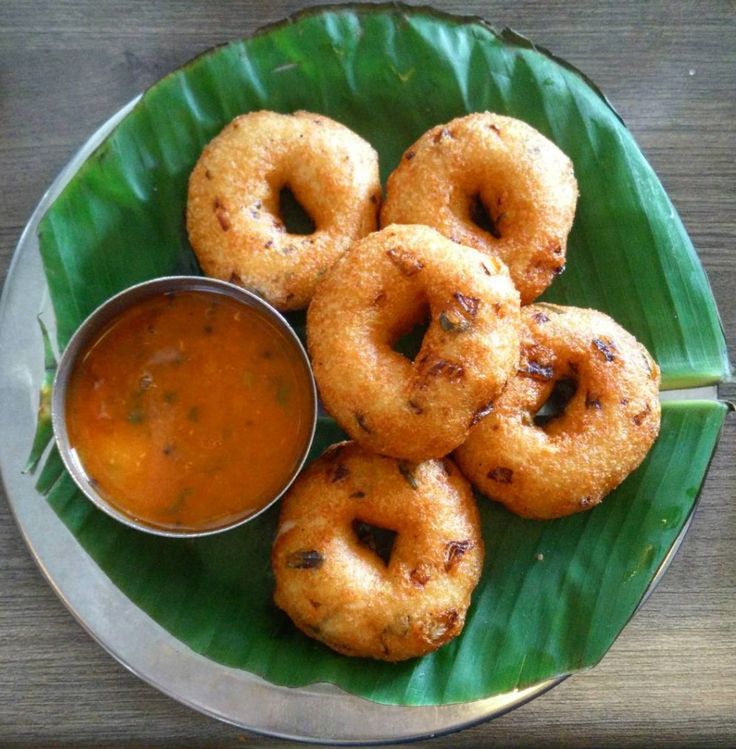 some fried food on a green plate with dipping sauce