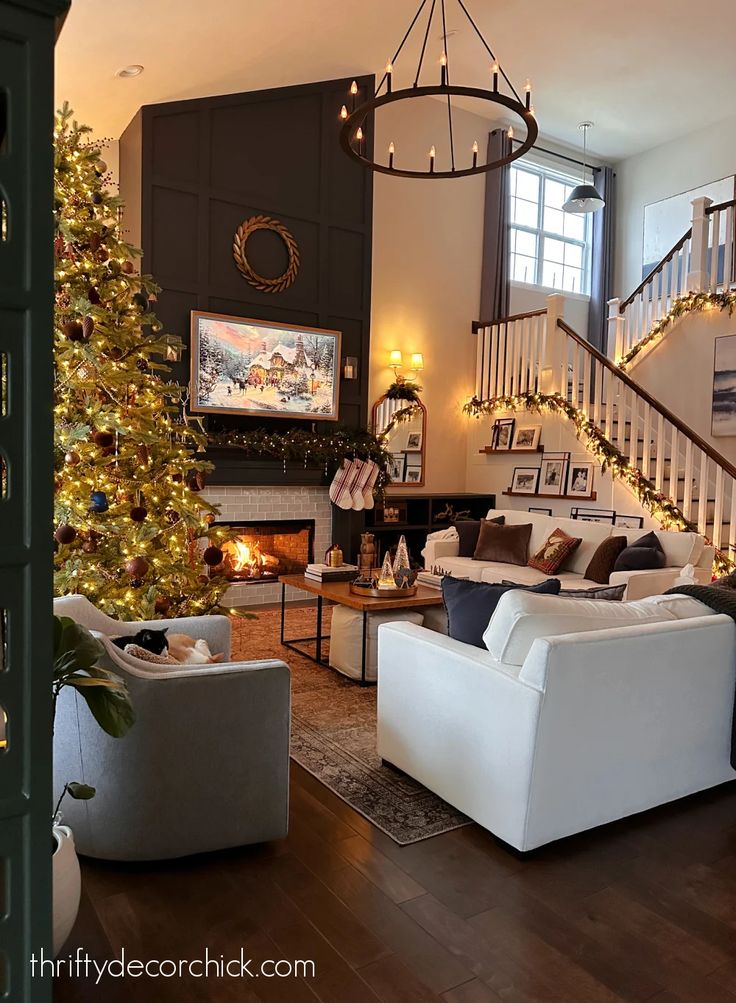 a living room filled with furniture and a christmas tree in front of a fire place