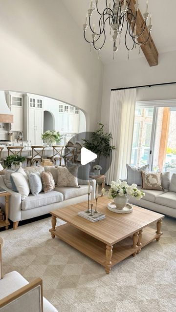 a living room filled with furniture and a chandelier