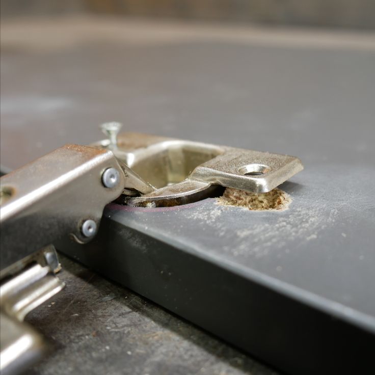 a piece of metal that has been placed on top of some kind of table with holes in it