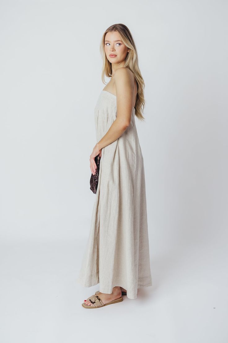 Expertly crafted from premium-quality linen, the Zabina Maxi Dress offers a stylish and comfortable option for all your warm-weather activities. This gem is lightweight, ultra-comfortable, and thanks to its removable straps, a beautifully versatile addition to your wardrobe. FIT: Runs true to size - relaxed fit. MATERIAL: 100% Linen. GARMENT DETAILS: Relaxed maxi dress in 100% linen, with removable spaghetti straps. Features dual in-seam pockets, with a back button closure and gently-defined empire waist. SIZE GUIDE: S (2-4) / M (6-8) / L (10-12) MODEL DETAILS: Heather is wearing size S. Mackenzie - Size S Heather - Size S Molly - Size XL Our Brunette Misses Model Our Blonde Misses Model Our Blonde Curve Model Bust 34" 34" 37" Waist 27.5" 27.5" 32" Hips 40.5" 37.5" 47" Height 5'7" 5'7" 5'7 Linen Sundress Maxi Dress For Daywear, Linen Sundress For Daywear, Linen Maxi Dress For Spring, Spring Maxi Linen Dress, Chic Linen Maxi Dress For Day Out, Spring Linen Dress For Beach, Beige Linen Dress For Beach, Beige Linen Dress For The Beach, Beige Flax Linen Dress For Beach