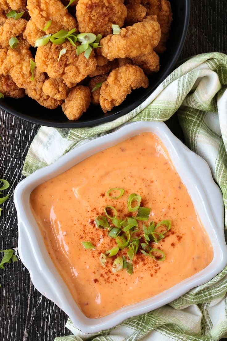 a bowl of dipping sauce next to some fried food