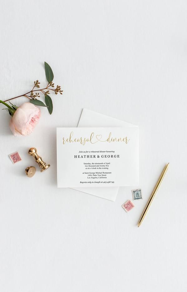 the wedding stationery is laid out next to some flowers