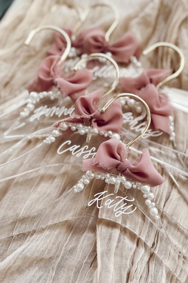 three hair clips with bows on them sitting on top of a bed next to each other