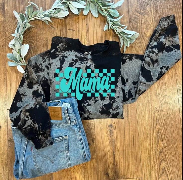 a cropped sweatshirt with the word mama printed on it and two pairs of jeans