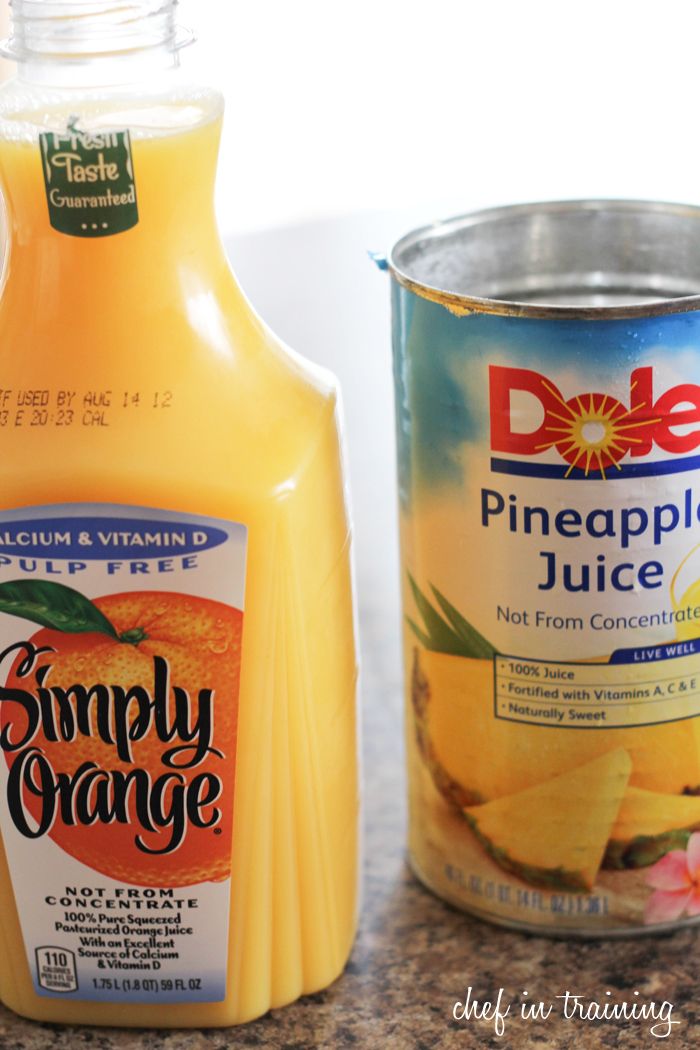 orange juice and pineapple juice are on the counter next to a canister of peaches