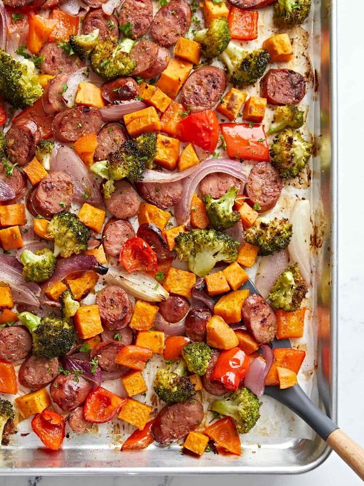 a sheet pan filled with sausage, broccoli and sweet potato casserole