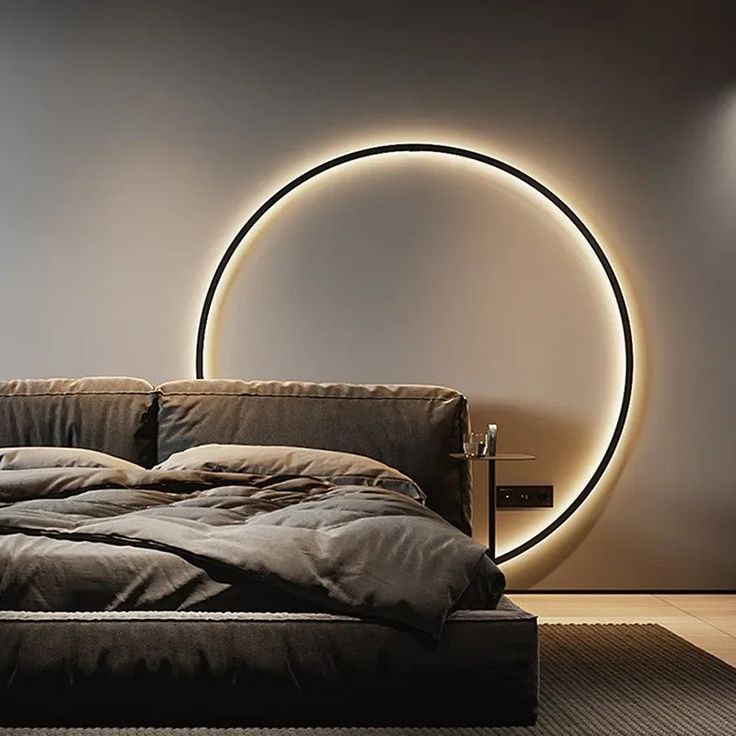 a bedroom with a circular light above the bed