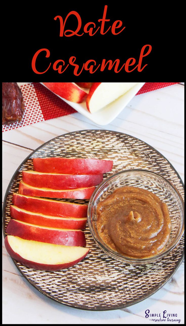 an apple slice on a plate with peanut butter and caramel sauce in the middle