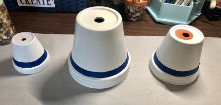 three white and blue cups sitting on top of a counter