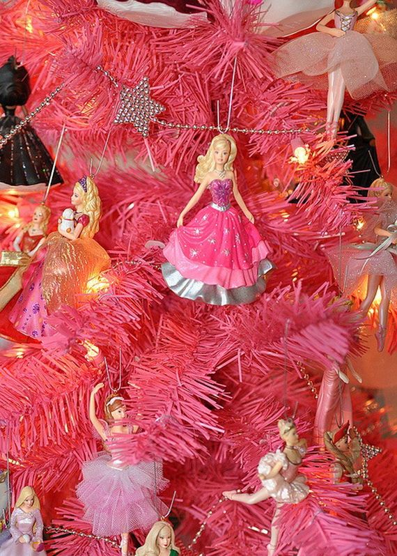 a pink christmas tree with barbie dolls on it