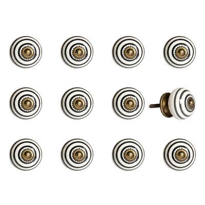 a bunch of white and gold knobs on a white background with some brown buttons in the middle