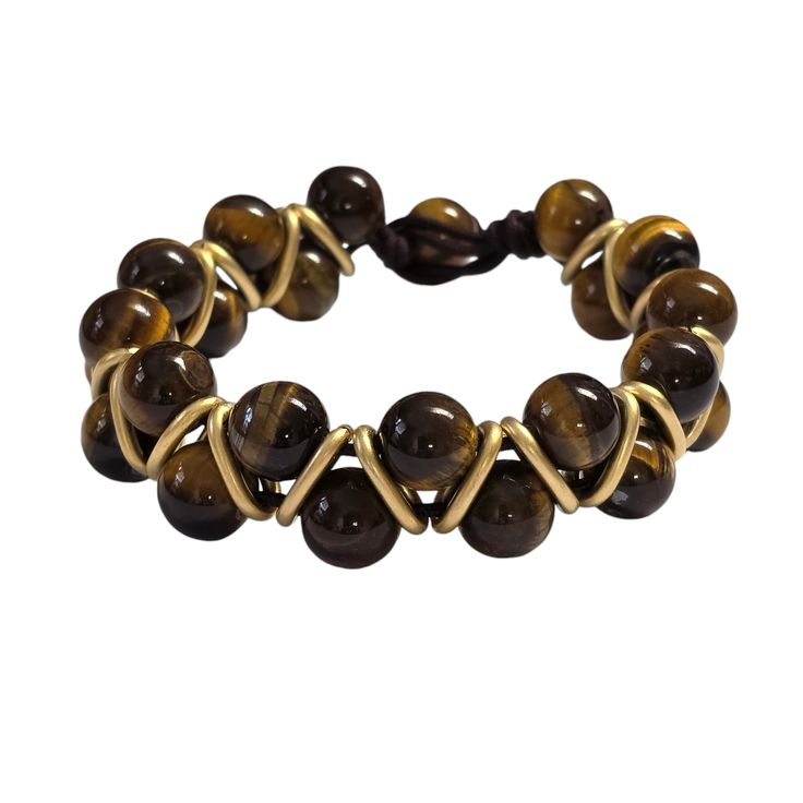 Details:- 10mm Tigers Eye- Size: 7.75"- Gold accents- Macramé toggle closure- Genuine natural stones MATERIAL: Sturdy black adjustable cord. For long-lasting wear for years to come, we suggest not to wear this in the ocean, shower, or in the pool due to the harsh chemicals. Tigers Eye is an incredible healing stone and can be used in many ways to; align certain chakras, balance the body, sharpen the mind, and help you unpack and put away any emotional baggage you have been dragging around with y Adjustable Wire Wrapped Braided Bracelet As Gift, Adjustable Round Jewelry With Sliding Knot, Adjustable Beaded Braided Bracelet, Adjustable Braided Bracelets For Everyday, Everyday Adjustable Braided Bracelet, Adjustable Wire Wrapped Beaded Bracelets, Adjustable Wire Wrapped Brown Jewelry, Casual Adjustable Braided Bracelets With Natural Stones, Casual Braided Bracelets With Natural Stones