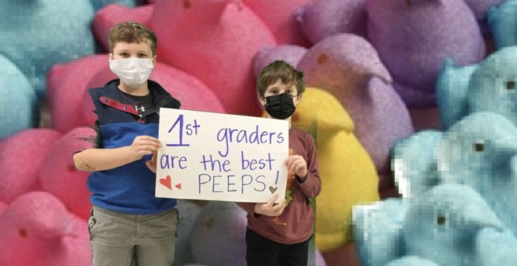 two boys wearing face masks and holding a sign that says 1st graders are the best peeps