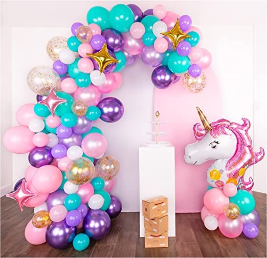 a unicorn balloon arch with balloons and confetti