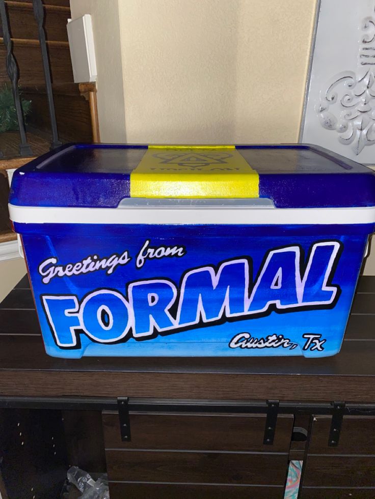 a blue ice chest sitting on top of a wooden table