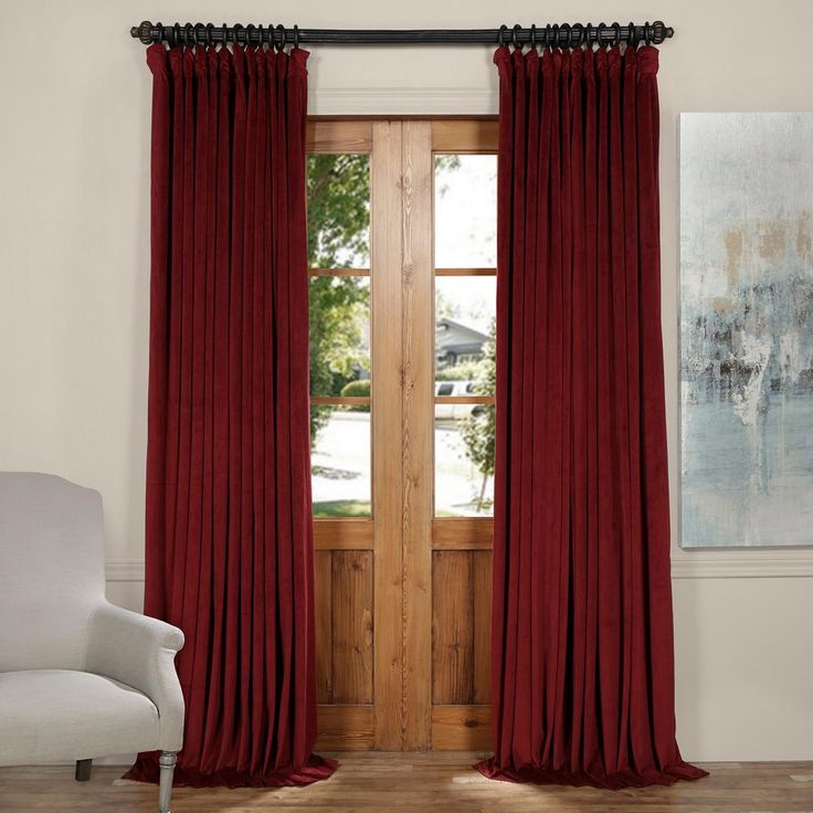 a pair of red curtains in front of a wooden door