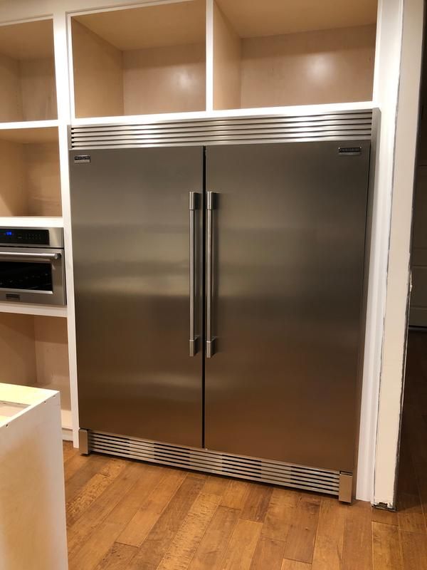 a large stainless steel refrigerator in a kitchen