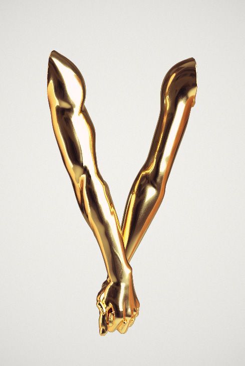 the letter v is made out of shiny gold foil and it looks like an animal's tail