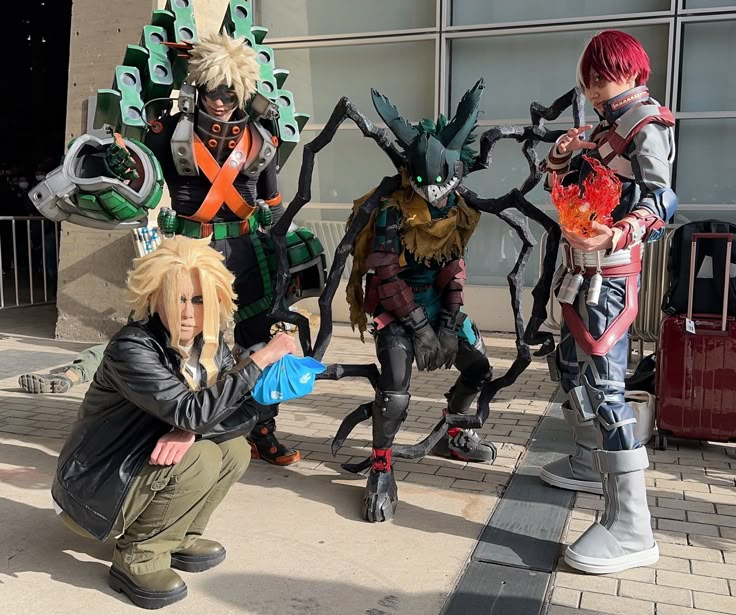 three anime cosplays are posing for a photo in front of a building