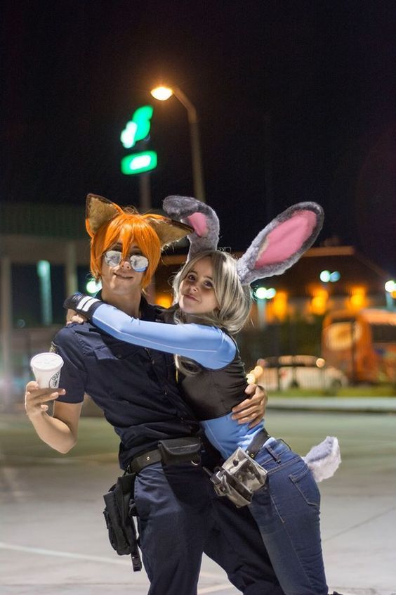 a man and woman dressed up as rabbits hugging each other in the middle of an intersection