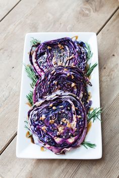 grilled red cabbage steaks on a white plate