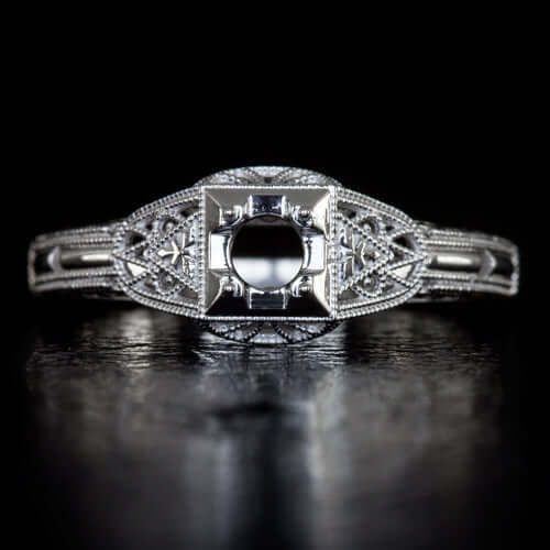 an antique style diamond ring with filigrees