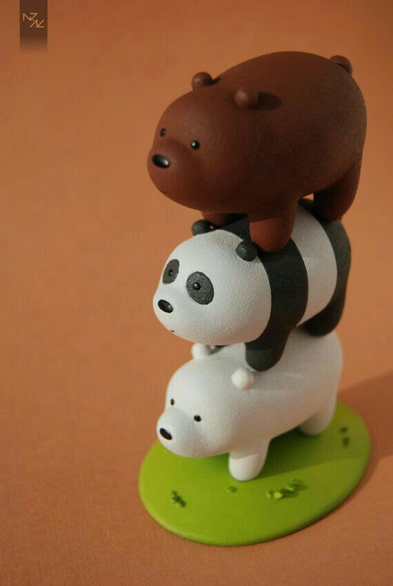 a small figurine with a bear on it's back sitting on top of another toy