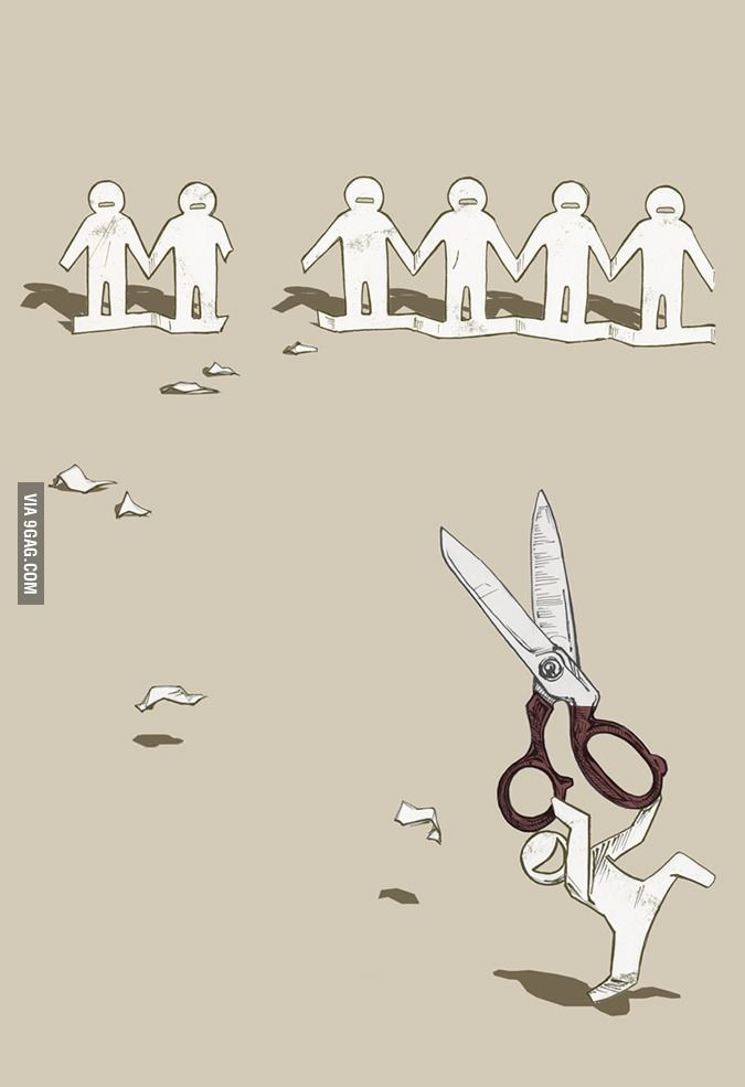 a pair of scissors that is in front of some paper cutouts with people holding hands