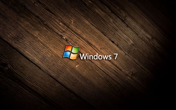 the windows 7 logo on a wooden surface