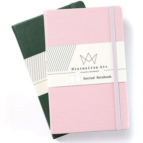 two pink and green notebooks sitting side by side on top of each other,