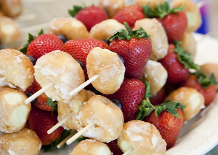 strawberries and pretzels are arranged on skewers