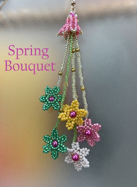 three beaded flowers are hanging from a hook with the words spring bouquet on it