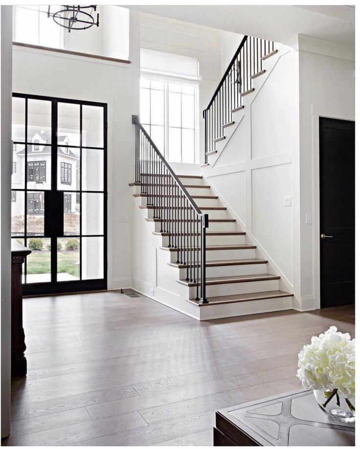 a living room filled with furniture and a stair case