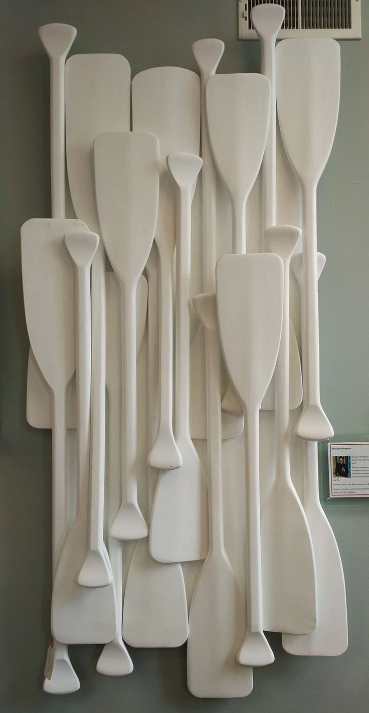 a group of white utensils hanging on a wall